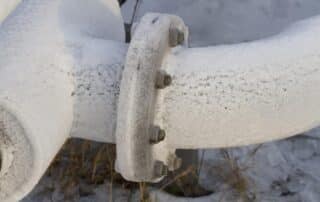A frost-covered metal pipe in a freezing environment, illustrating the risks of frozen pipes during winter. When temperatures drop, water inside pipes can freeze, expand, and cause potential bursts, leading to costly damage. Homeowners should act quickly to prevent plumbing issues by insulating pipes, keeping faucets dripping, and maintaining indoor heat. If pipes freeze, turn off the main water supply, apply heat using a hairdryer or heating pad, and avoid open flames. For severe cases, professional help is essential. What to Do When Your Pipes Freeze? Contact Afterhours Plumbing & Drainage Services for emergency assistance. Their expert team specializes in thawing frozen pipes, preventing bursts, and restoring water flow efficiently. Available 24/7, they ensure quick and reliable service to protect homes from winter plumbing disasters. Don't wait for major damage—call Afterhours Plumbing & Drainage Services at the first sign of frozen pipes. Stay safe and prevent costly repairs!